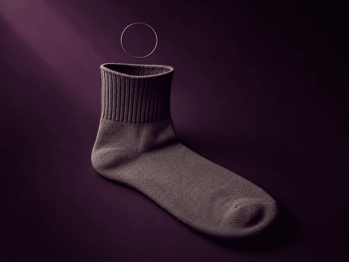 A loose-cuff sock lying flat with its cuff relaxed open