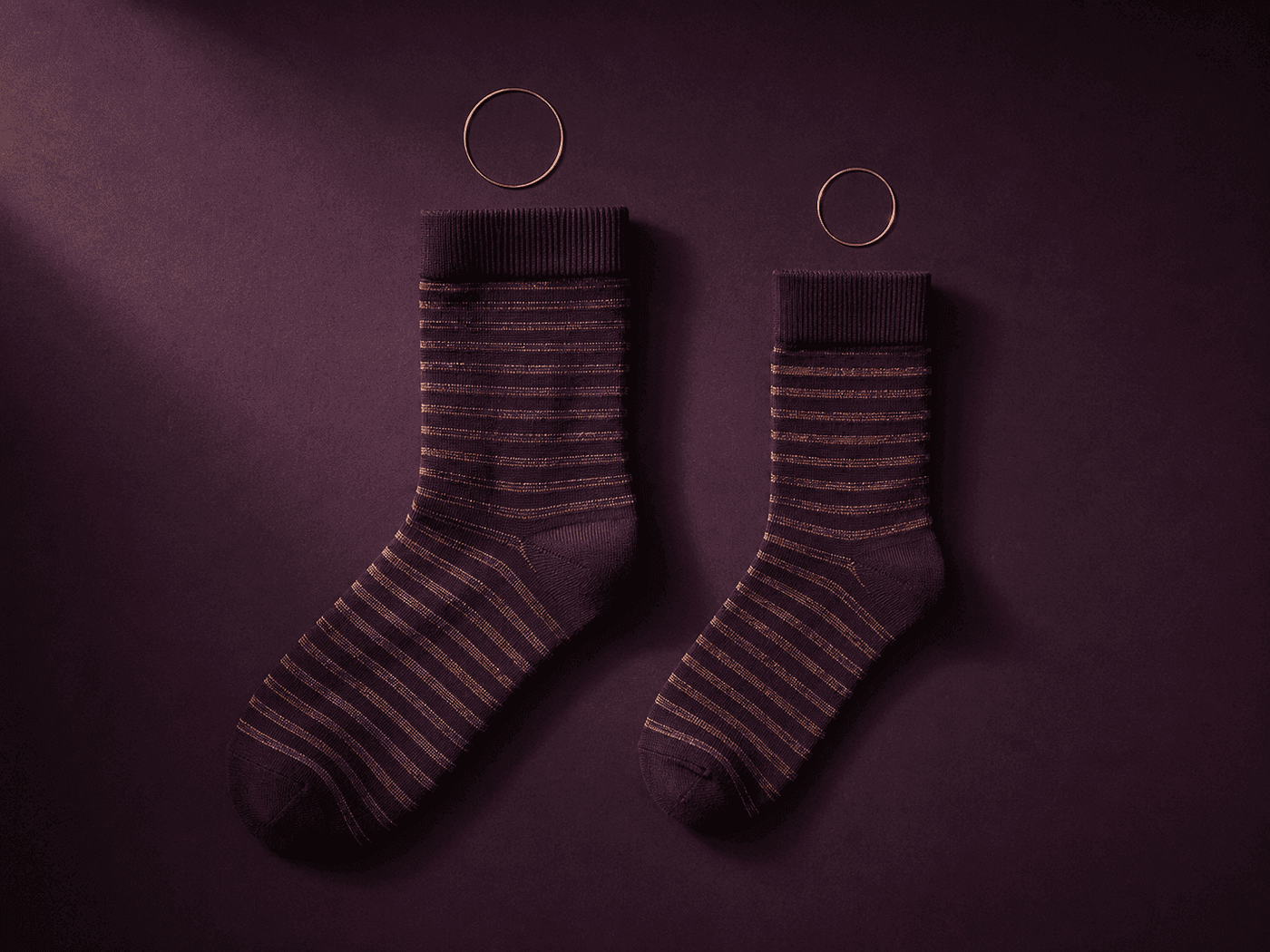Two socks of the same style side by side, one visibly larger than the other